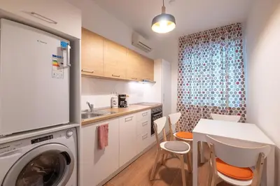 a kitchen with a washing machine and a table at Sophisticated Gem with Private parking in Sofia