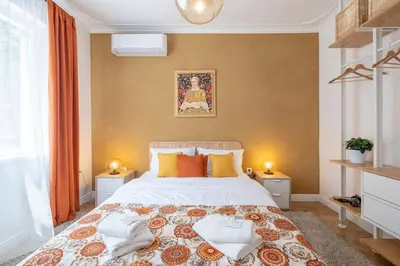 a bedroom with a large bed and two night stands at Sophisticated Gem with Private parking in Sofia