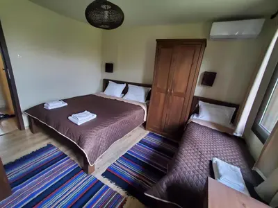 a small bedroom with a bed and a cabinet at Villa Kashtata in Resilovo