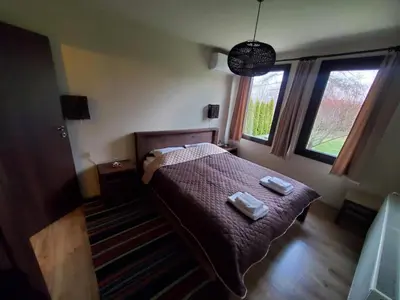 a bedroom with a bed with two towels on it at Villa Kashtata in Resilovo