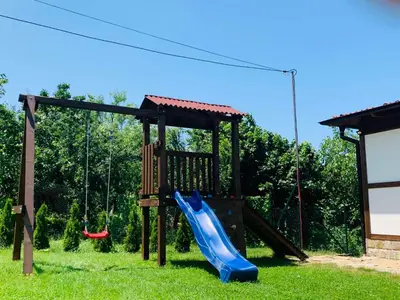a playground with a slide and a swing at Villa Kashtata in Resilovo