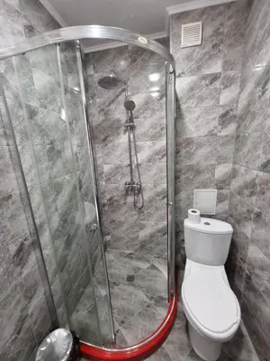 a bathroom with a shower with a toilet in it at NAYS in Madan