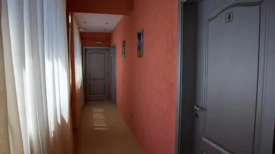 an empty hallway with orange walls and a door at NAYS in Madan