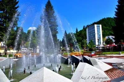 a fountain in a park with people in the water at NAYS in Madan