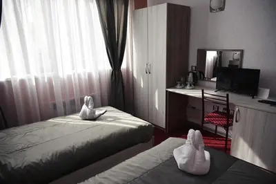 a hotel room with two beds with towels on them at NAYS in Madan