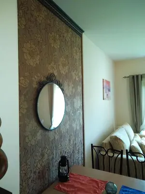 a room with a mirror on a wall with a table at Ски апартамент, студио Хрис, Лъки Пампорово in Pamporovo