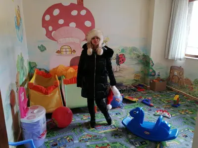 a woman is standing in a room with toys at Ски апартамент, студио Хрис, Лъки Пампорово in Pamporovo