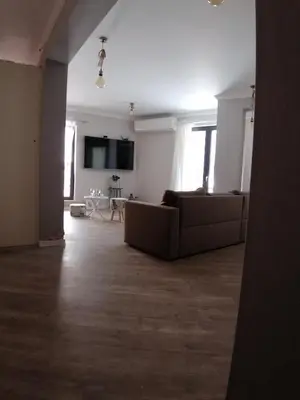 a living room with a couch and a tv at Casa Lavenda in Plovdiv