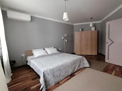a bedroom with a bed and a wooden floor at Casa Lavenda in Plovdiv