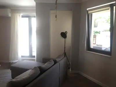 a living room with a couch and a window at Casa Lavenda in Plovdiv