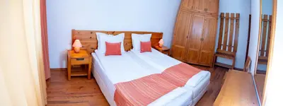 a bedroom with a large bed with red pillows at Two bedroom apartments in Murphys Lodge in Bansko