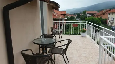 a patio with chairs and a table on a balcony at Къща за гости DANI DREAM in Sapareva Banya