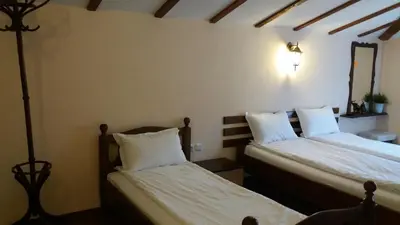 two beds in a room with white pillows at Къща за гости DANI DREAM in Sapareva Banya