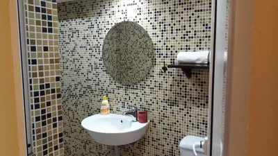 a bathroom with a sink and a mirror at Къща за гости DANI DREAM in Sapareva Banya