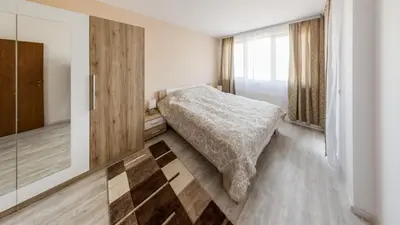 a bedroom with a bed and a glass door at NEXT TO GONDOLA Stylish and Charming apartment in Bansko