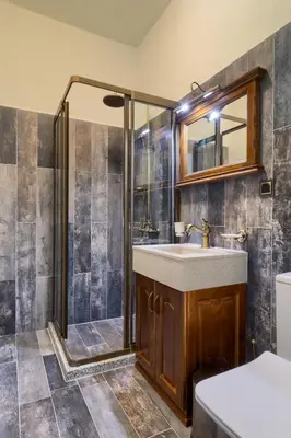 a bathroom with a shower and a sink at Hotel Apostolite in Sandanski