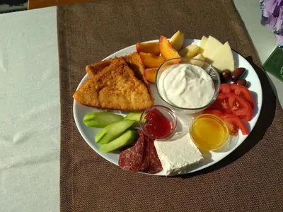 a plate of food with different types of food on a table at Hotel Apostolite in Sandanski