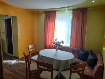 a living room with a table and a couch at ВИЙГ in Sapareva Banya