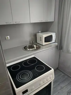 a kitchen with a stove and a microwave at ВИЙГ in Sapareva Banya