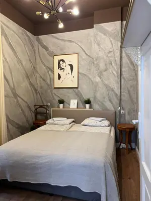 a bedroom with a bed and a stone wall at 4us - 24h Self Check-in in Sofia