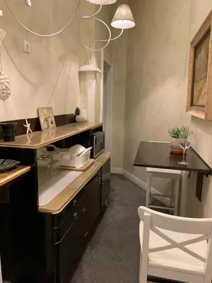 a kitchen with a counter and a white chair at 4us - 24h Self Check-in in Sofia