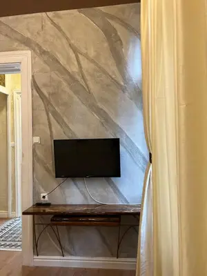 a flat screen tv sitting on top of a wall at 4us - 24h Self Check-in in Sofia
