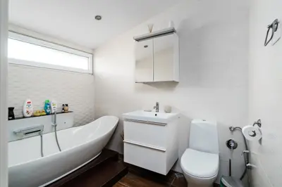 a white bathroom with a sink and a toilet at 3BDR The Hadjis - City Center Flat in Sofia
