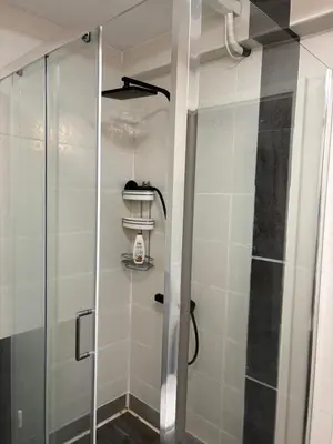 a shower with a glass door in a bathroom at Lilia 4 Self-Check in apartment in Sofia