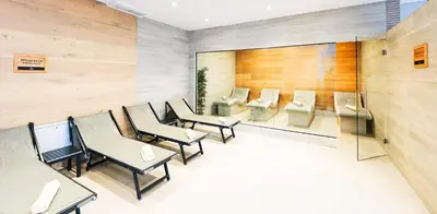 a waiting room with tables and chairs and a mirror at Predela LUX Aparthotel in Bansko