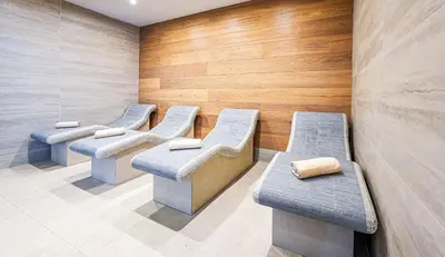 a row of benches in a waiting room at Predela LUX Aparthotel in Bansko