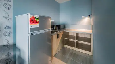 a small kitchen with a stainless steel refrigerator at A&M Hotel with free parking in Plovdiv