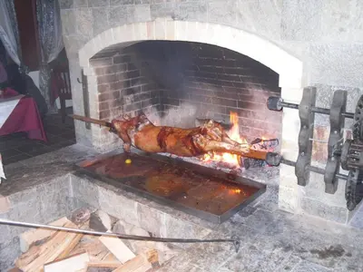 a turkey is cooking in a brick oven at Borika Hotel in Chepelare