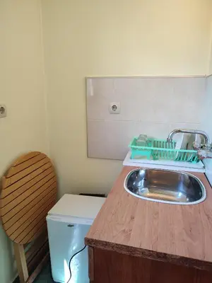 a small bathroom with a sink and a toilet at Къща за гости M-Stone in Bansko