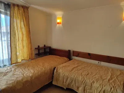 a bedroom with two beds and a window at Къща за гости M-Stone in Bansko