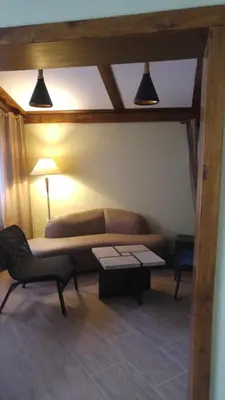 a living room with a couch and a table at Relax in Dobrinishte