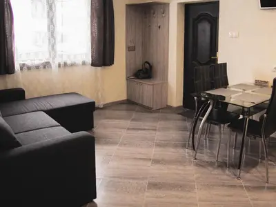 a living room with a couch and a table at Relax in Dobrinishte