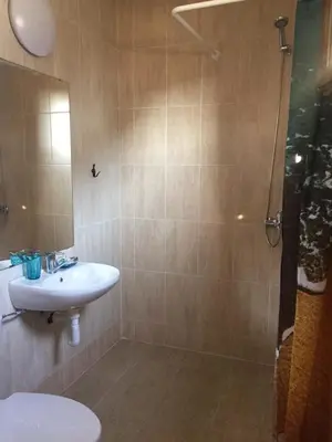 a bathroom with a toilet and a sink and a shower at Комплекс Кали, к.к. Цигов Чарк in Tsigov Chark