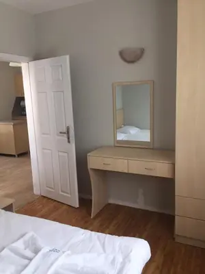 a bedroom with a bed and a mirror on a dresser at Комплекс Кали, к.к. Цигов Чарк in Tsigov Chark