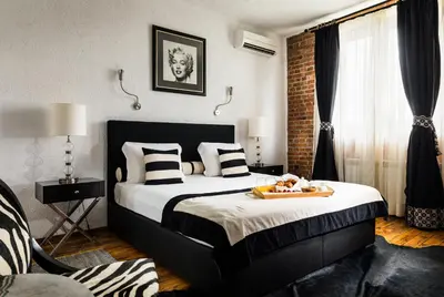 a bedroom with a bed with a tray of food on it at Chateau Copsa Complex in Moskovets