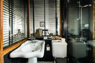 a bathroom with a sink and a toilet at Chateau Copsa Complex in Moskovets