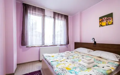 a bedroom with a bed with towels on it at Alex apartment in Velingrad