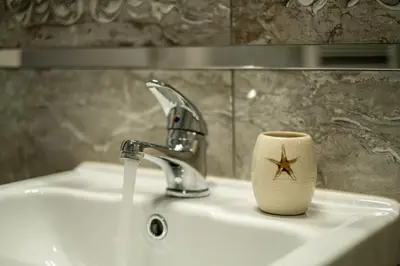 a bathroom sink with a star coffee mug on it at Alex apartment in Velingrad