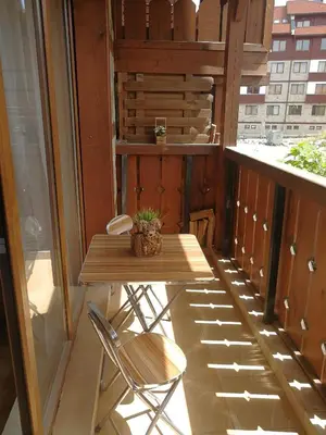 a small table and two chairs on a balcony at G-Apartment, New Inn, 2-rooms in Bansko