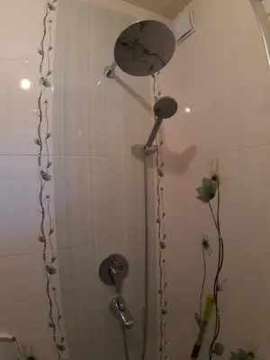 a shower with a shower head in a bathroom at Малко oазисче in Sofia