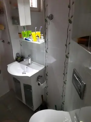 a bathroom with a white sink and a toilet at Малко oазисче in Sofia