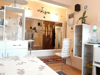 a kitchen with a table and a chair in a room at Малко oазисче in Sofia