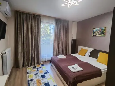 a hotel room with two beds and a window at Madini apartment in Velingrad