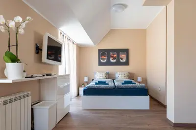 a bedroom with a bed with blue sheets at Studio Talisman in Sofia