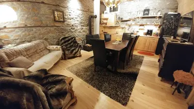 a living room with a couch and a table at EskiZ - Our stone home in Chepelare