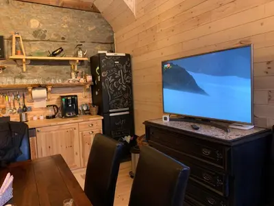 a television sitting on top of a dresser in a kitchen at EskiZ - Our stone home in Chepelare